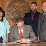 Gov. Mike Dunleavy (center) signs a proclamation ending the COVID-19 Emergency Declaration in the Alaska State Capitol on April 30, 2021. Dunleavy was joined by House Minority Leader Rep. Cathy Tilton, R-Wasilla (left) DHSS Commissioner Adam Crum(right), and Senate President Peter Micciche, R-Soldotna(far right). (Courtesy Photo / Office of Gov. Mike Dunleavy)