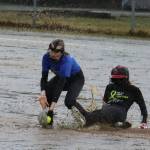 JDHS Gloria Bixby slides safe into second base and under the tag of TMHS Jenna Dobson during the first inning of a drizzly Friday night game against Thunder Mountain High School. JDHS leaped out to a 7-0 lead in the first inning and wound up winning 15-0. (Ben Hohenstatt / Juneau Empire)