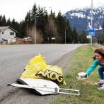 Juniper Harris, 6, an aspiring member of Girl Scout Troop 4009, adds litter to a pile along Mendenhall Loop Road during the annual Juneau Litter Free Community Cleanup on Saturday, May 1. (Ben Hohenstatt / Juneau Empire)