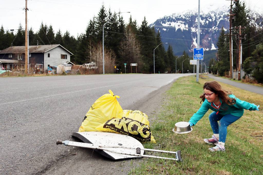 Juniper Harris, 6, an aspiring member of Girl Scout Troop 4009, adds litter to a pile along Mendenhall Loop Road during the annual Juneau Litter Free Community Cleanup on Saturday, May 1. (Ben Hohenstatt / Juneau Empire)