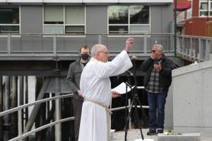 Fr. Gordon Blue takes part in the 31st annual Blessing of the Fleet and Reading of Names at the Alaska Commercial Fishermens Memorial in Juneau on May 1, 2021. (Michael S. Lockett / Juneau Empire)