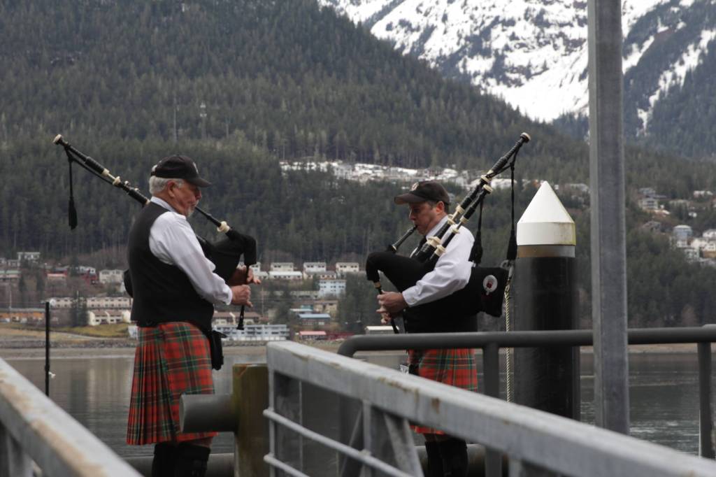 Members of the City of Juneau Pipe Band play their bagpipes during the 31st annual Blessing of the Fleet and Reading of Names at the Alaska Commercial Fishermens Memorial in Juneau on May 1, 2021. (Michael S. Lockett / Juneau Empire)