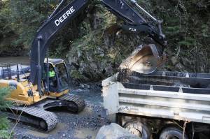 Workers with City and Borough of Juneau Parks and Recreation clear the basin at Cope Park of excess sediment and other material washed down the waterway on Sept. 16, 2020. This work is an example of one of the many varied jobs done by public servants and recognized during Public Service Recognition Week, which ends May 8. (Michael S. Lockett / Juneau Empire File)