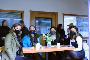 Fashion enthusiasts and retail boutique buyers and owners from around the state and the Pacific Northwest descended on Juneau to preview fall collections from local and national designers during the first-ever Alaska Fashion Week. Here, Qaulluq of Kotzebue, Inuraaq of Nome, Carley Thayer and Suzanne Nierra, both of Juneau, watch Saturday's runway show from inside the Harris Building. The windows were removed so spectators could watch models as they came down Shattuck Way, which served as the runway for the event. (Dana Zigmund/Juneau Empire)