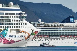 A fishing vessel is dwarfed by the Norwegian Cruise Lines Norwegian Jewel and Norwegian Pearl in Juneaus downtown harbor in September 2014. The U.S. Senate on Thursday passed a bill that could allow cruise ships to come to Alaska. (Michael Penn / Juneau Empire File)