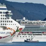 A fishing vessel is dwarfed by the Norwegian Cruise Lines Norwegian Jewel and Norwegian Pearl in Juneaus downtown harbor in September 2014. (Michael Penn / Juneau Empire File)