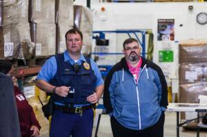 Alaska State Trooper Josh Bentz, left, addresses volunteers searching for a missing woman in Juneau before they set out on May 21, 2021. (Michael S. Lockett / Juneau Empire)