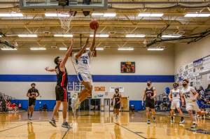 Thunder Mountain High School player Meki Toutaoilepo, battles for a basket. (Courtesy Photo/Heather Holt)