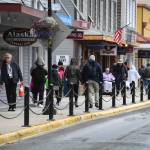 Pedestrians walk along South Franklin Street in July 2019. (Michael Penn / Juneau Empire File)
