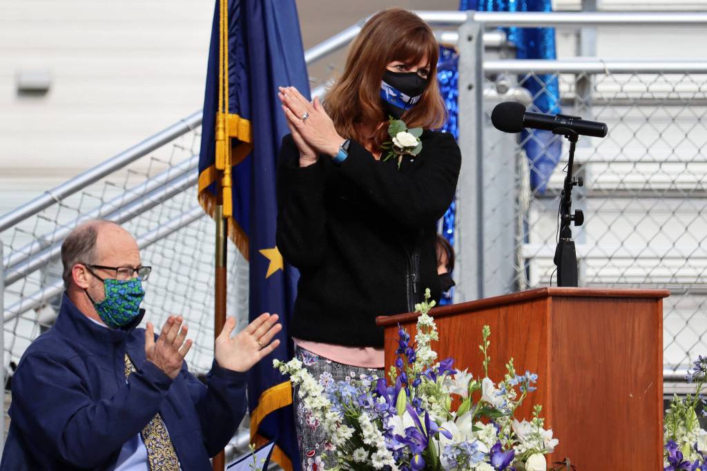Thunder Mountain High School teacher James Marks and Juneau School District Superintendent Bridget Weiss give the TMHS Class of 2021 a round of applause. In opening remarks, Weiss said grit will be second nature to the class of 2021. (Ben Hohenstatt / Juneau Empire)