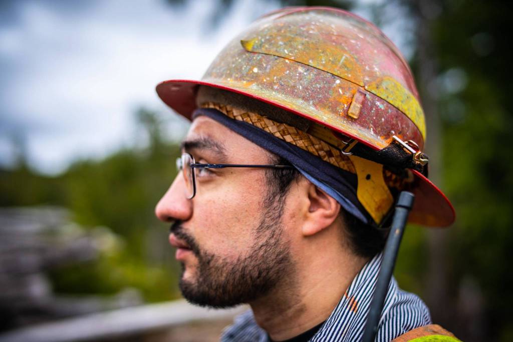 Michael Melendrez with the United States Forest Service wears the cedar headband he wove during the workshop beneath his hard hat. Creating hands-on, experiential learning opportunities for agency staff with Haida artisans was a priority for the Tribal governments who hosted this workshop. (Courtesy Photo / Bethany Sonsini Goodrich)