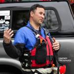 Capt. Jayme Johns, head of the Capital City Fire/Rescues water rescue team, briefs a group of CCFR personnel and Coast Guardsmen as they prepare to practice swiftwater rescues in the Mendenhall River on as National Boating Safety Week wraps up May 27, 2021. (Michael S. Lockett / Juneau Empire)