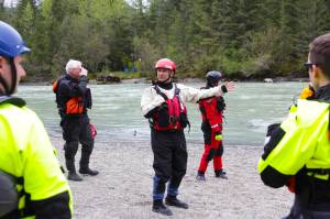 Capt. Jayme Johns, center, head of the Capital City Fire/Rescues water rescue team, briefs a group of CCFR personnel and Coast Guardsmen as they prepare to practice swiftwater rescues in the Mendenhall River on as National Boating Safety Week wraps up May 27, 2021. (Michael S. Lockett / Juneau Empire)