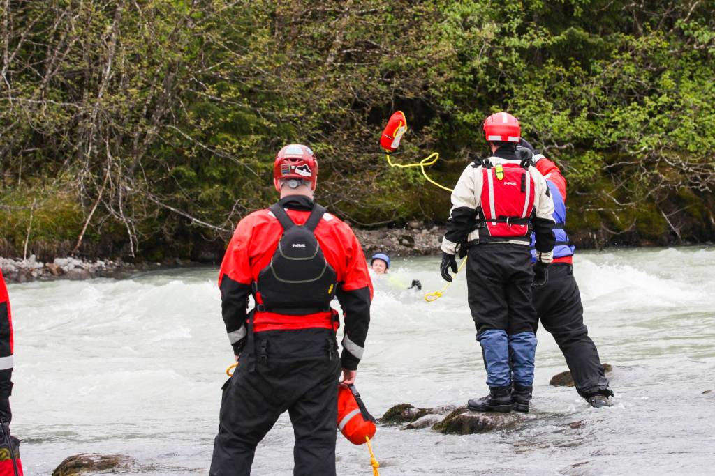 Capital City Fire/Rescue personnel and Coast Guardsmen practice swiftwater rescues in the Mendenhall River on as National Boating Safety Week wraps up on May 27, 2021. (Michael S. Lockett / Juneau Empire)