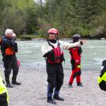 Capt. Jayme Johns, center, head of the Capital City Fire/Rescues water rescue team, briefs a group of CCFR personnel and Coast Guardsmen as they prepare to practice swiftwater rescues in the Mendenhall River on as National Boating Safety Week wraps up May 27, 2021. (Michael S. Lockett / Juneau Empire)