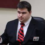 David Timothy dons a state championship ring he won as a student manager with the Juneau-Douglas High School: Yadaa. at Kalé basketball team and a recently acquired coach name tag. Timothy, who has Down syndrome, was recently named an assistant basketball coach at JDHS after he passed a coaching certification exam administered by the National Federation of High Schools. (Ben Hohenstatt / Juneau Empire)