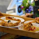 Plates of fried Louisiana soft shell crab with Creole tomato, Louisiana crab ravigote, red chili and basil oils and torn herbs served at a charity dinner highlighting Alaska and Louisiana seafood at Forbbiden Peak Brewery on Tuesday, June 8, 2021. (Peter Segall / Juneau Empire)