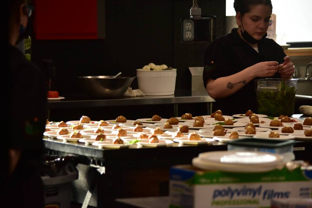 Red Spruce chefs prepare a dessert of New Orleans beignets with Alaskan foraged elderflower pastry cream, Alaskan devils club ice cream at a charity dinner highlighting Alaska and Louisiana seafood at Forbbiden Peak Brewery on Tuesday, June 8, 2021. (Peter Segall / Juneau Empire)