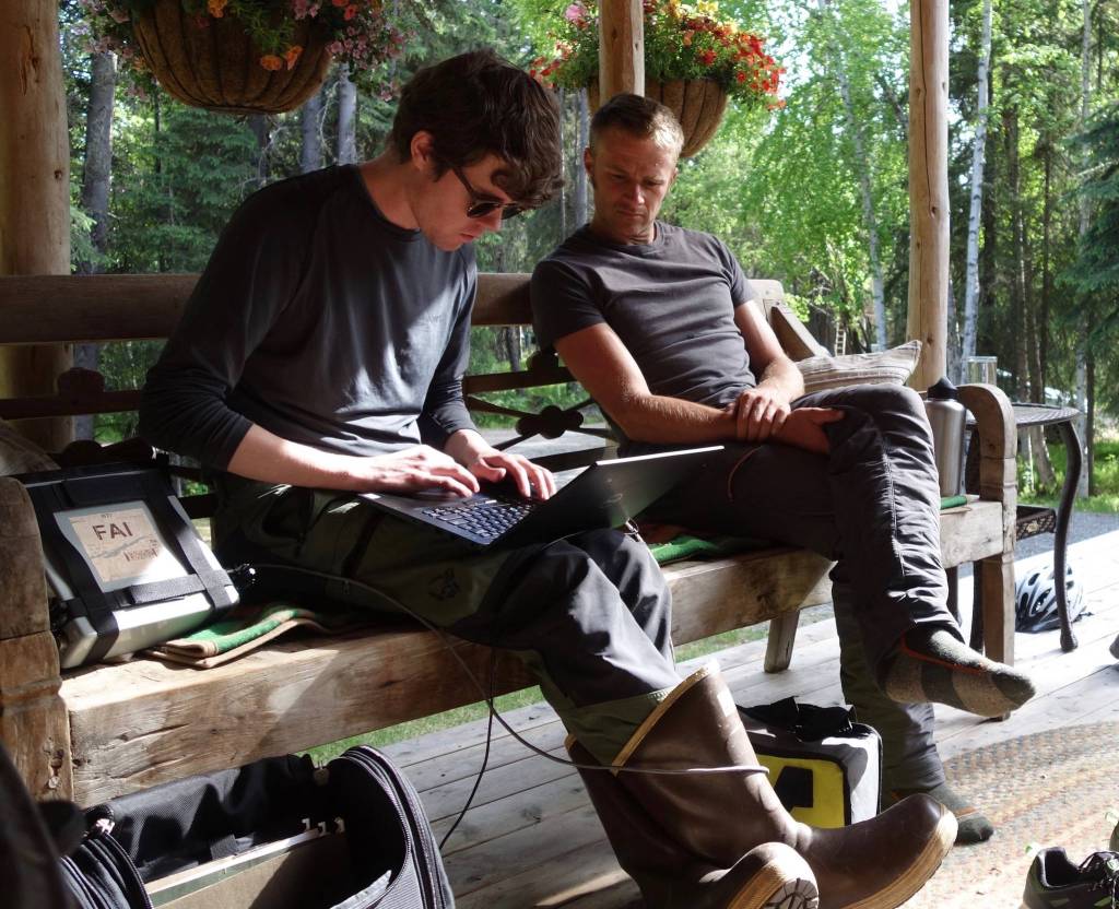 On a Fairbanks homeowners porch, Nicholas Hasson, left, and Jason Clark of UAF review results from permafrost investigations. (Courtesy Photo / Ned Rozell)