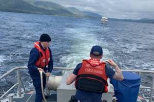 Coast Guard Station Ketchikan crew members, Petty Officer 3rd Class Corben Hill (left) and Petty Officer 3rd Class Caleb Hoskins work a tow line for a yacht near Ketchikan, after another Ketchikan crew medevaced the yachts captain June 9, 2021. The earlier boat crew worked with paramedics from South Tongass Volunteer Fire Department to transport the 86-year-old yacht captain to EMS on shore, after he experienced stroke symptoms. (Fireman George Haver / USCG)