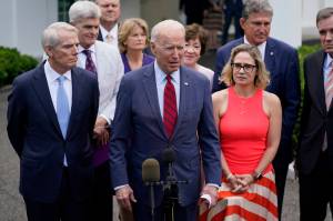 President Joe Biden, with a bipartisan group of Senators, including Alaska's Lisa Murkowski, speaks Thursday June 24, 2021, outside the White House in Washington. Biden invited members of the group of 21 Republican and Democratic senators to discuss the infrastructure plan. (AP Photo / Evan Vucci)