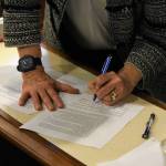 House Speaker Louise Stutes, R-Kodiak, signs an agreement with Minority Leader Cathy Tilton, R-Wasilla, on Monday, June 28, 2021, part of a deal to pass a budget and avoid a government shutdown on July 1. The agreement said lawmakers should form a working group to draft recommendations for resolving the states budget deficit at another special session in August. (Peter Segall / Juneau Empire)