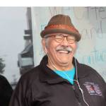 Walter Alexander Soboleff Jr., listens to the story he shared and narrated for the Juneau Voices audio walk on June 24, 2021. His story recounts the struggles he had growing up as the child of prominent Alaskan Native leader and minister Walter Soboleff, namesake of building listeners look out on while hearing the installation. He wore his late father's hat to a recent celebration of the project. (Dana Zigmund/Juneau Empire)