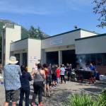 A firefighter hot dog sale on Douglas draws a crowd. (Dana Zigmund / Juneau Empire)
