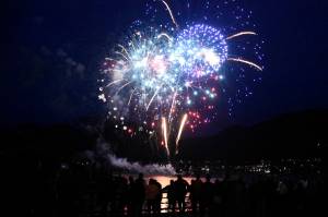Fireworks light up the night sky over the Gastineau Channel with reds, whites and blues in the early hours of the Fourth of July. (Peter Segall / Juneau Empire)