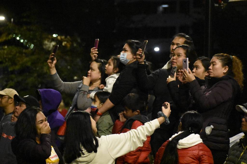 People take photos and video of the Juneau fireworks display on July 4, 2021. (Peter Segall / Juneau Empire)