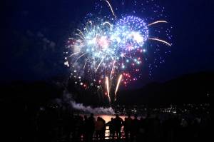 Fireworks light up the night sky over the Gastineau Channel with reds, whites and blues in the early hours of the Fourth of July. Personal fireworks were being shot off nearby, leading one onlooker to shout, “Double fireworks! I love America!” (Peter Segall / Juneau Empire)