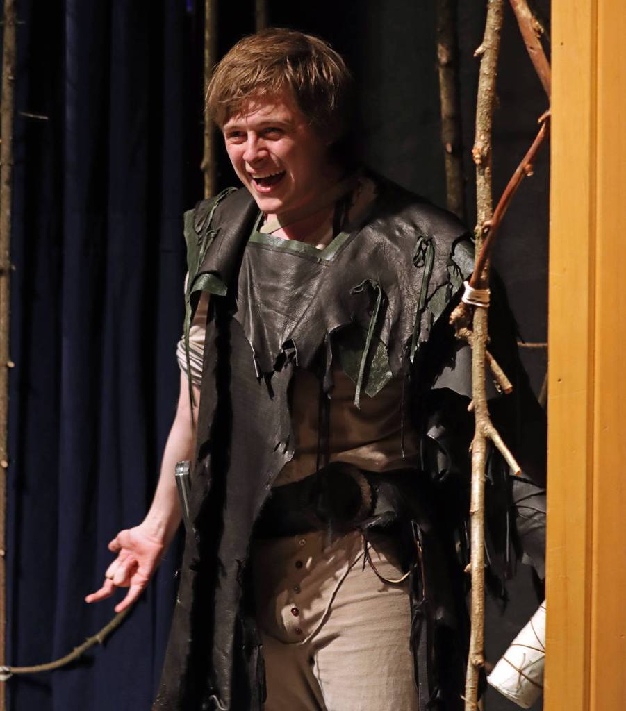 A bottle-clutching Caliban (Ben Krall) cackles in celebration of new-found freedom and libation during a Monday rehearsal performance of The Tempest held in McPhetres Hall. (Ben Hohenstatt / Juneau Empire)