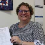 Beth McEwen, municipal clerk for the City and Borough of Juneau, holds a packet of forms in her office on Monday. The forms are ones candidates must complete to be added to the ballot for Octobers municipal election. Candidates for the election must complete all filing steps by Monday, July 26 at 4:30 p.m. (Dana Zigmund / Juneau Empire)