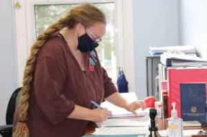 Deputy City Clerk Diane Cathcart finalizes the list of candidates seeking office in the October municipal election on Monday afternoon. On Monday, races for seats on both the City and Borough of Juneau Assembly and Juneau School District Board of Education took shape. (Dana Zigmund / Juneau Empire)