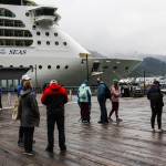 Tourists mill near the Serenade of the Seas, the first large cruise ship to come to Juneau in 2021, on Friday, July 23. (Michael S. Lockett / Juneau Empire)