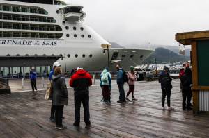 Tourists mill near the Serenade of the Seas, the first large cruise ship to come to Juneau in 2021, on Friday, July 23. (Michael S. Lockett / Juneau Empire)