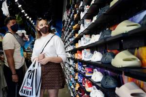 Shoppers wear masks inside of The Cool store in the Fairfax district of Los Angeles. The Centers for Disease Control and Prevention reversed course Tuesday, July 27, 2021, on some masking guidelines, recommending that even vaccinated people return to wearing masks indoors in parts of the U.S. where the coronavirus is surging. City and Borough of Juneau officials are considering extending local mitigation measures that advise residents to wear masks when in indoor public spaces. (AP Photo/ Marcio Jose Sanchez)