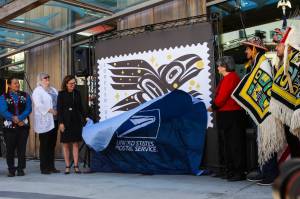 Michael S. Lockett / Juneau Empire
Officials, artists and key Southeast Alaska figures alongside U.S. Postal Service leadership unveil the Raven Story stamp as part of the official release ceremony in front of the Sealaska Heritage Institutes Walter Soboleff Building on Friday, July 30, 2021.