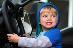 Bodhi Race, 3, beams in the driver’s seat of an emergency vehicle during National Night Out on Tuesday evening. Race was among the children who attended the festivities on Rivercourt Way. Emergency responders, police, animal control officers, firefighters and search and rescue personnel interacted with the community for the annual even. (Ben Hohenstatt / Juneau Empire)