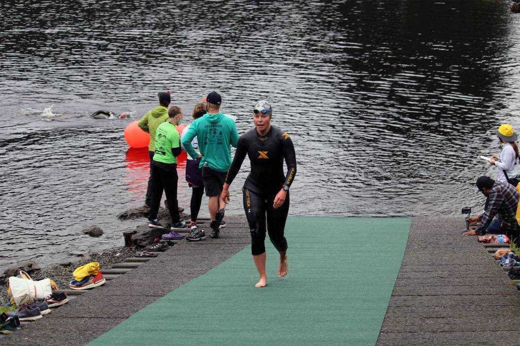 A swimmer emerges from Auke Lake as part of the Aukeman Triathlon on Saturday, August 7. (Dana Zigmund/Juneau Empire)