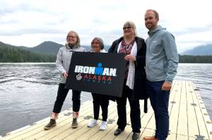 Travel Juneau CEO and President Liz Perry, Sealaska Heritage Institute President Rosita Worl, City and Borough of Juneau Mayor Beth Weldon, and Ironman regional director Dave Christen hold a sign for the 2022 Juneau Ironman event as they announce the races Alaska debut on the University of Alaska- Southeast campus on Aug. 9, 2021. (Michael S. Lockett / Juneau Empire)