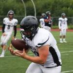 Ben Hohenstatt/Juneau Empire 
Hunter Derr, who plays for the Juneau Huskies, secures a pass from quarterback Noah Chambers, during a Tuesday evening practice outside Thunder Mountain High School.