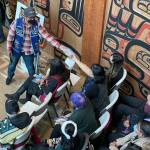 Michael S. Lockett / Juneau Empire
Participants in a ceremony commemorating the settlement in an intellectual property lawsuit against a fashion company take cuttings of the commercial garment at the center of the case on Friday, Aug. 13, 2021.