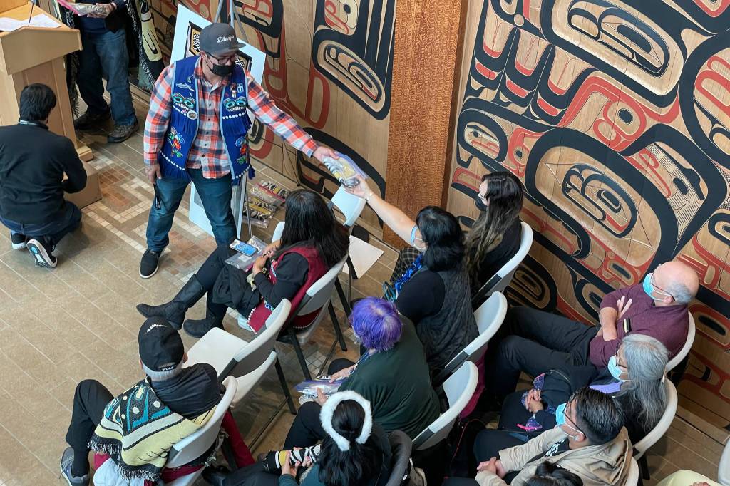 Michael S. Lockett / Juneau Empire
Participants in a ceremony commemorating the settlement in an intellectual property lawsuit against a fashion company take cuttings of the commercial garment at the center of the case on Friday, Aug. 13, 2021.