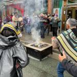 Michael S. Lockett / Juneau Empire 
Participants burn an example of a commercial garment that led to a now-settled intellectual property lawsuit in a ceremony commemorating the settlement with the fashion company on Friday, Aug. 13, 2021.