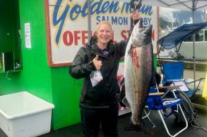 Tiffany Listberger poses with her 31.7-pound king salmon turned in at the Auke Bay weight station on Sunday. According to provisional results, Listberger is the winner of the 75th annual Goldern North Salmon Derby. (Courtesy photo / Derek Listeberger)