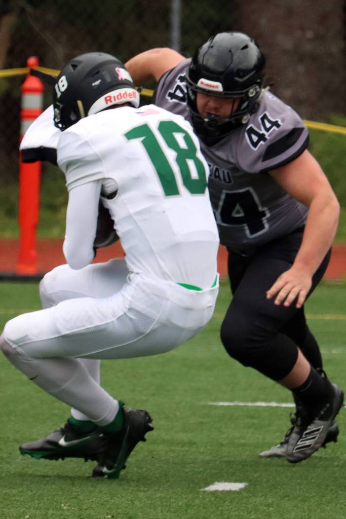 Hunter Derr sacks the Colony High School quarterback to force a turnover on downs early in Saturdays home-opener. (Ben Hohenstatt / Juneau Empire)