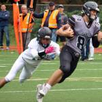photos by Ben Hohenstatt / Juneau Empire 
Wallace Adams makes his way up field after catching a pass Saturday. In addition to his work as a receiver, Adams opened scoring for Juneau with a field goal and forced a key fumble. Right, Noah Chambers throws the ball downfield
