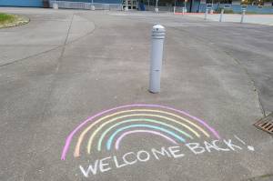 A sidewalk-based message welcomes students and staff back to Sít Eetí Shaanàx-Glacier Valley School ahead of the first day of school on Monday, Aug. 16.