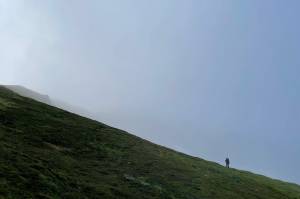 The author's wife makes her way across a mountain during an unsuccessful hunt with friends. (Jeff Lund / For the Juneau Empire)
